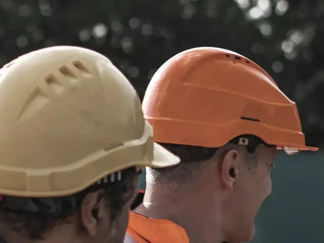 Construction workers in safety helmets
